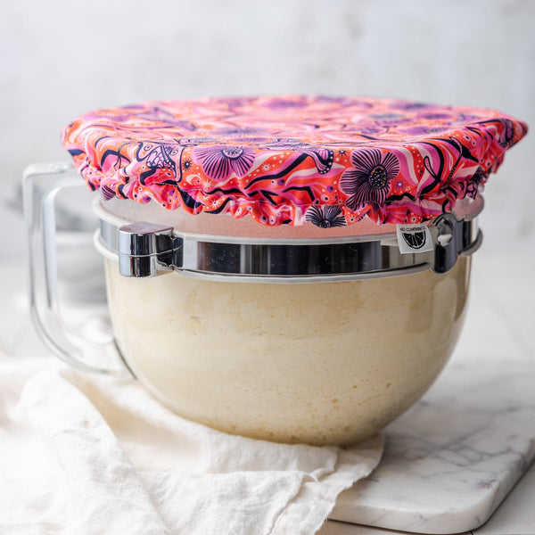 Bowl with a pink floral cover on a white background