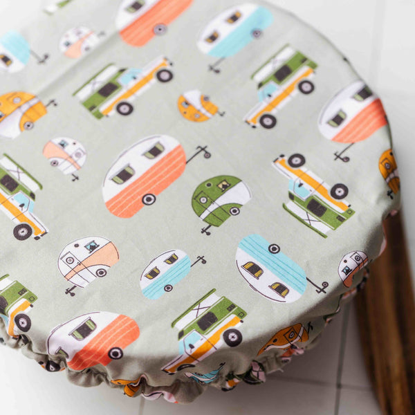 Round cushion with camper pattern on a white surface