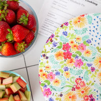 Eco-friendly reusable dish cover, a white background with a rainbow of watercolor florals