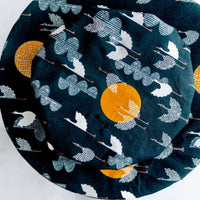 Deep cobalt blue reusable bowl cover with cranes flying amongst clouds and moons print