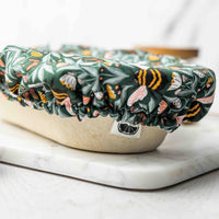 Floral-patterned cover on a white container with a marble surface background