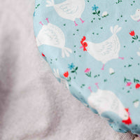 Fitted sheet with chicken pattern on a light blue background