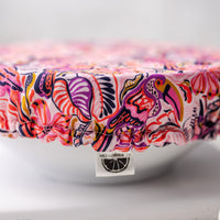 Colorful dish cover with a brand label on a white surface